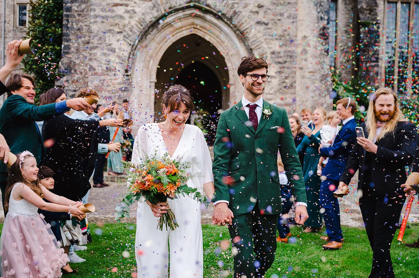 Confetti getting thrown over the happy newlyweds by London Wedding Photographer, By Jake Timms Photography