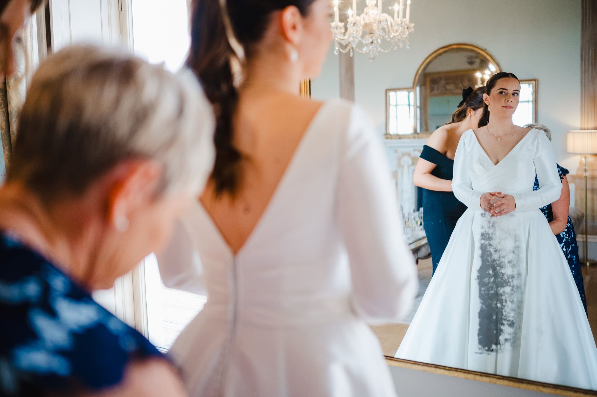 Bride having wedding dress done up by mother of the bride at Rockbeare Manor by Exeter Wedding Photographer Jake Timms Photography