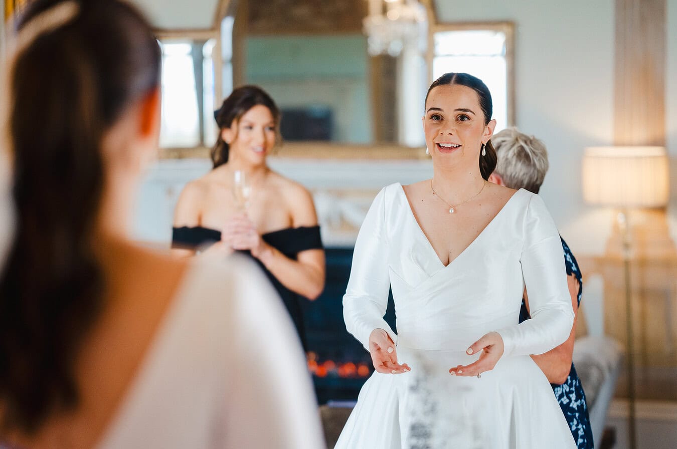 Bride having her wedding dress done up at Rockbeare Manor by Devon Wedding Photographer, Jake Timms Photography