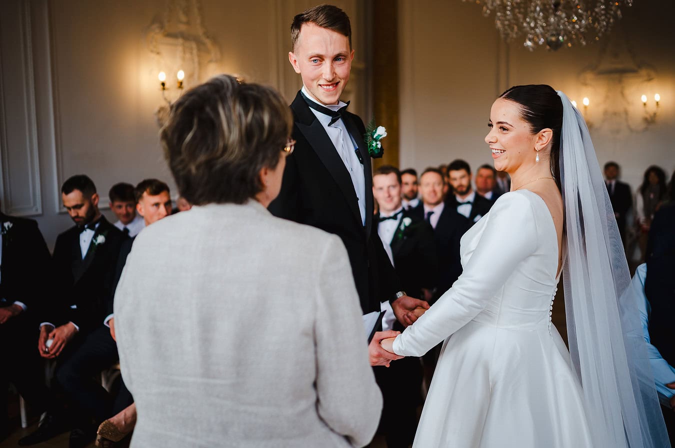Happy smiles as the happy couple hold hands as they say I do at Rockbeare Manor by Exeter Wedding Photographer Jake Timms Photography