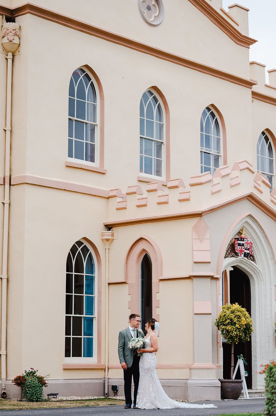 Couple standing outside of the grand Tawstock Court in Devon by Exeter Wedding Photographer Jake Timms Photography