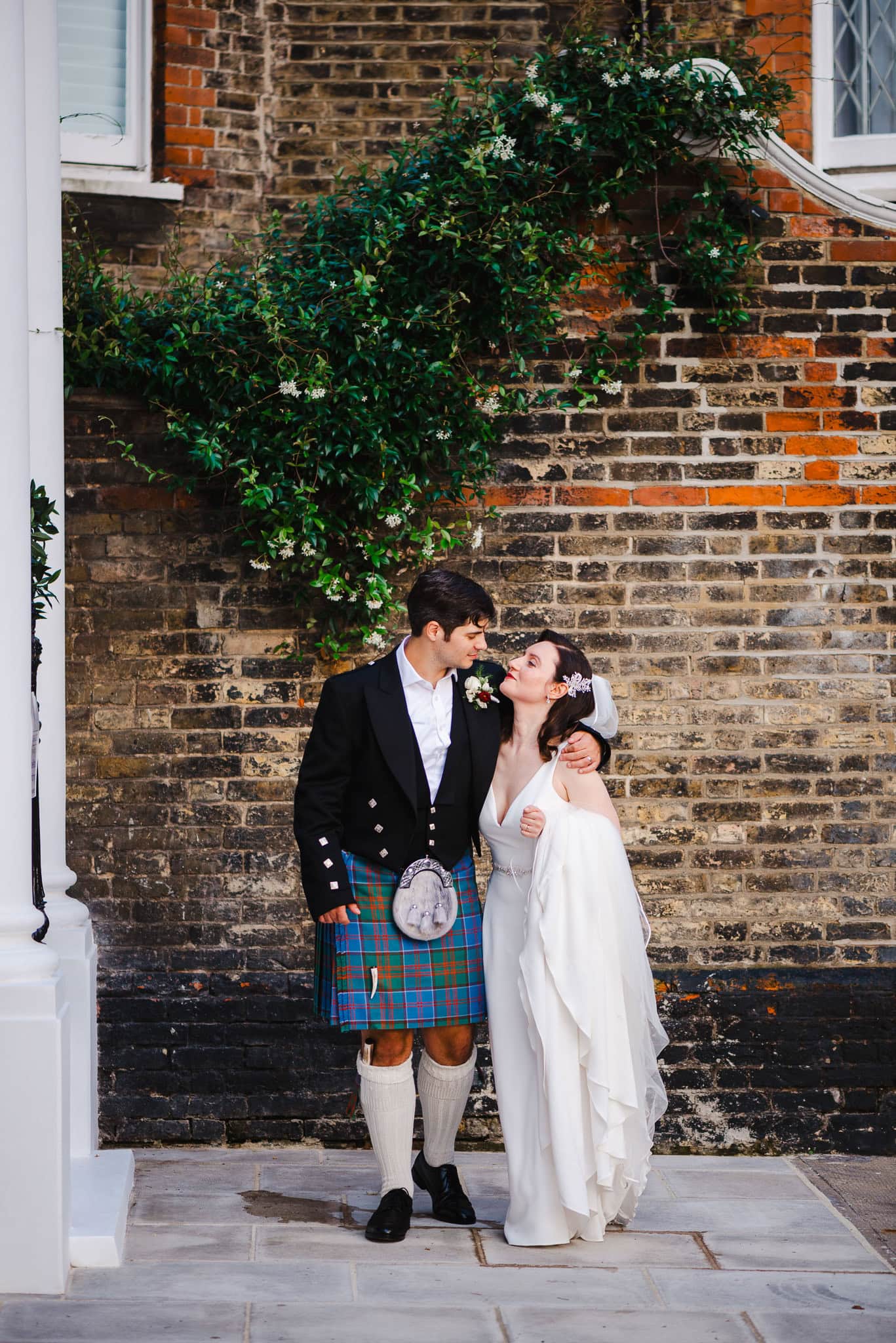 Bride and groom walk along a London street after their Kensington Wedding by London Wedding Photographer Jake Timms Photography