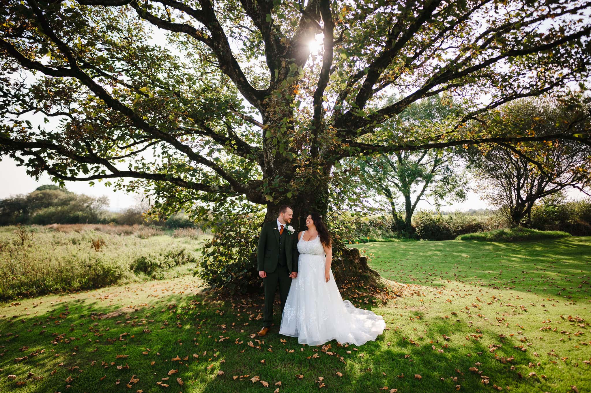 Couple photos beneath the beautiful autumnal tree at The Avalen - Wedding Video