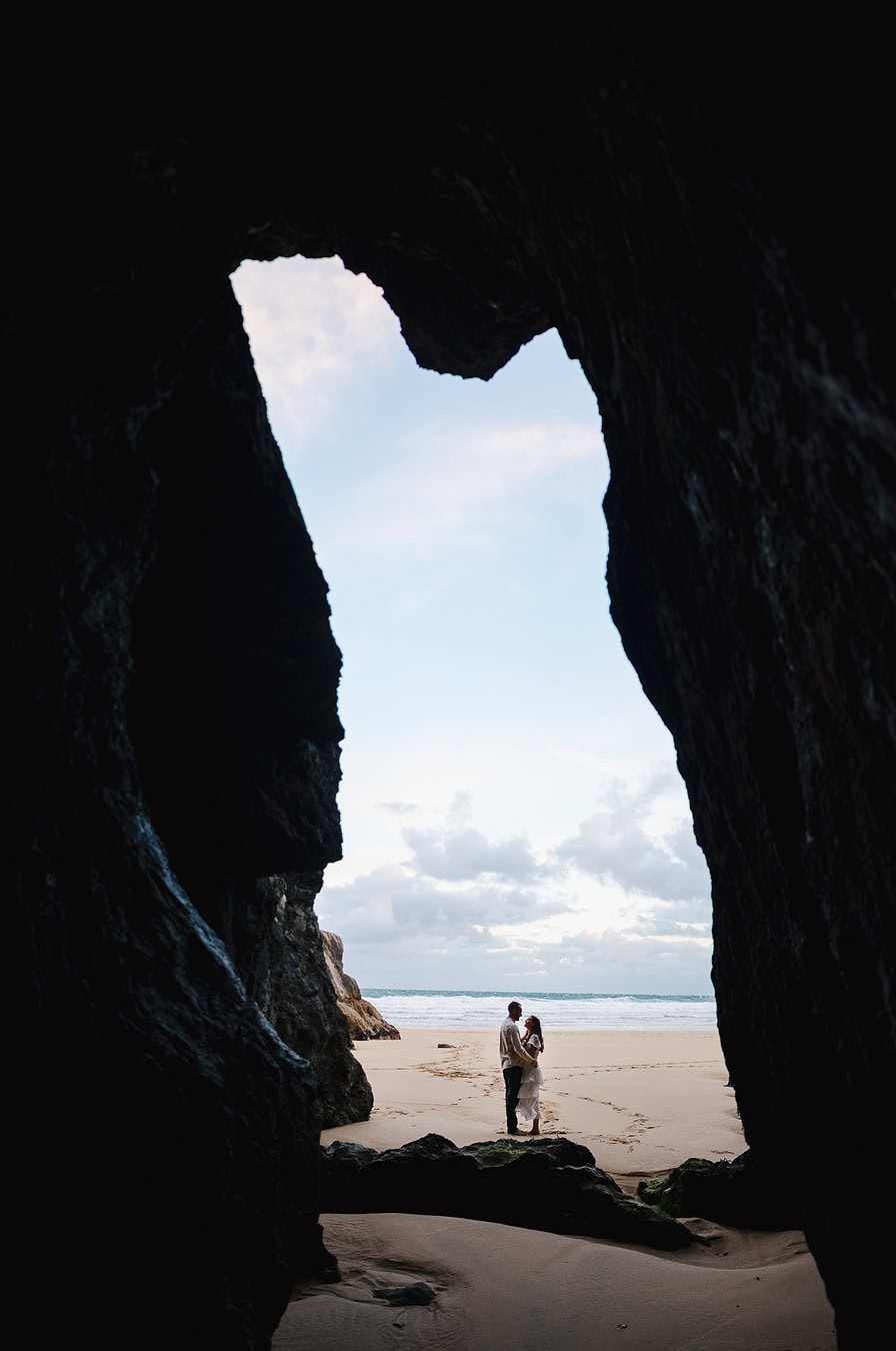 Standing at the entrance way to a cave in Cornwall