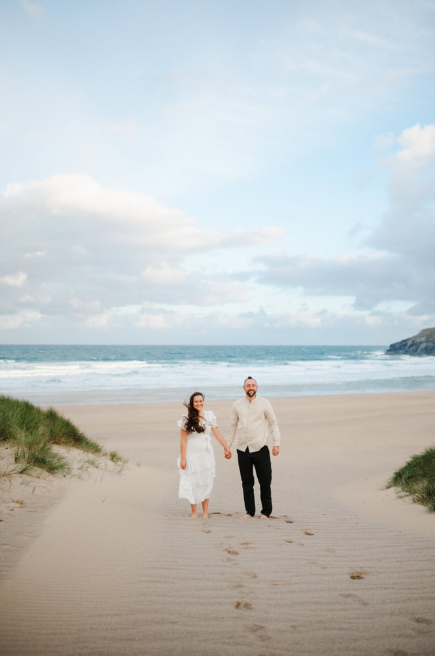 Standing proud on the sandy Holywell bay during their elopement celebrations - Elopement Portfolio