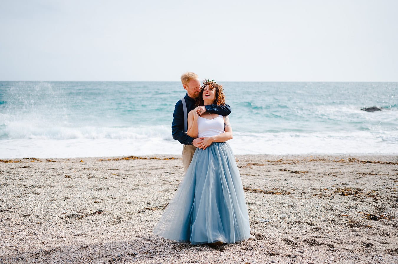 Love and laughter on a beach in Cornwall as the happy couple celebrate their Cornwall elopement - Elopement Portfolio