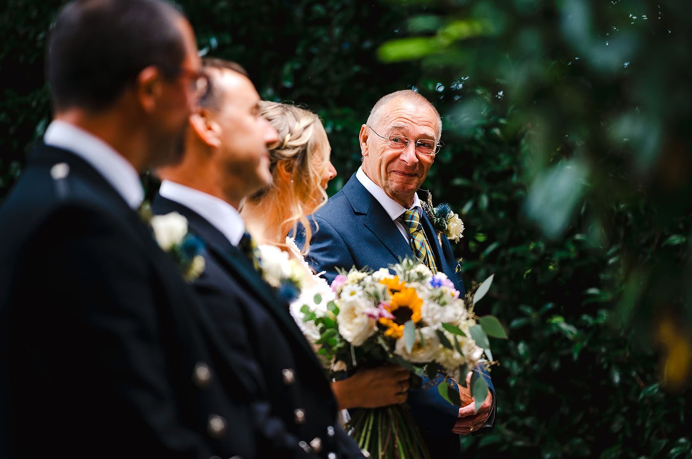 Father walks the bride down the aisle as he looks across towards the groom at a Heligan Gardens Wedding – Wedding portfolio For Jake Timms Photography