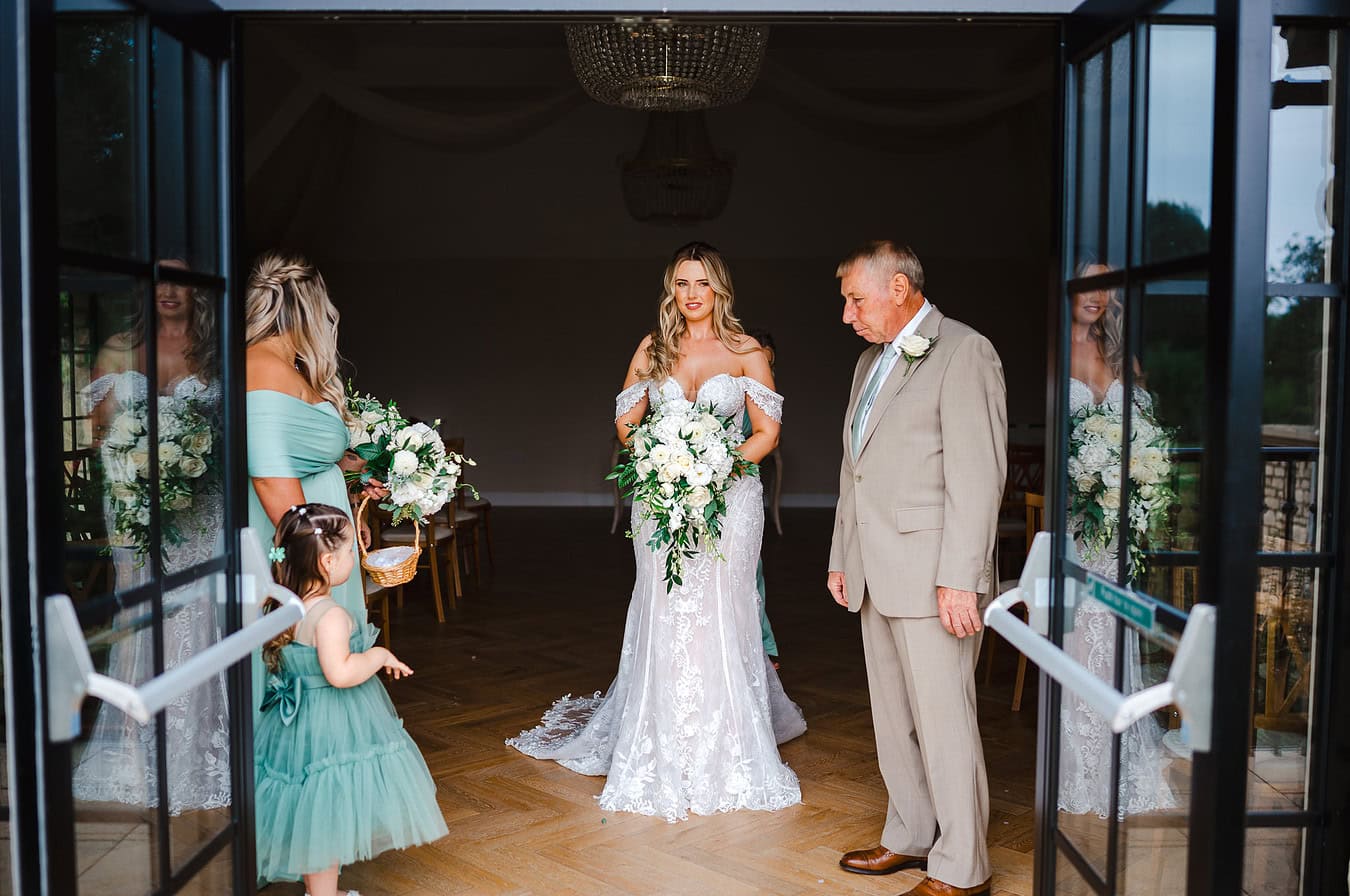Standing and waiting to leave the Pear Tree before walking down the aisle to her outdoors wedding - Wedding Portfolio
