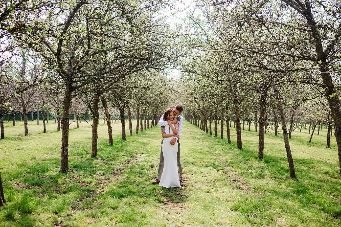 Happy couple hug in the orchards at Froginwell Vineyard - Best of Wedding photography 2024