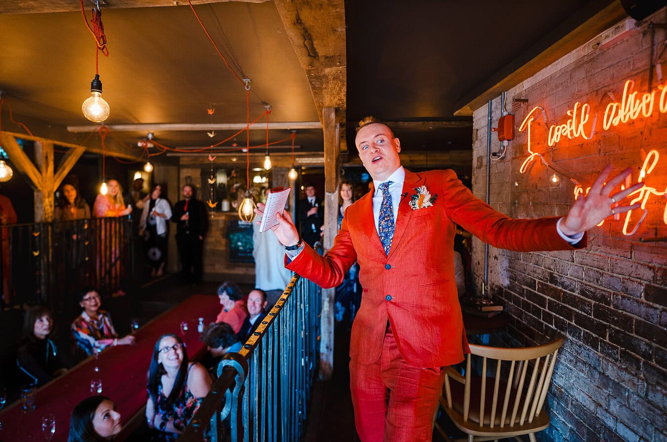 The groom pulling a unique pose during his wedding speech