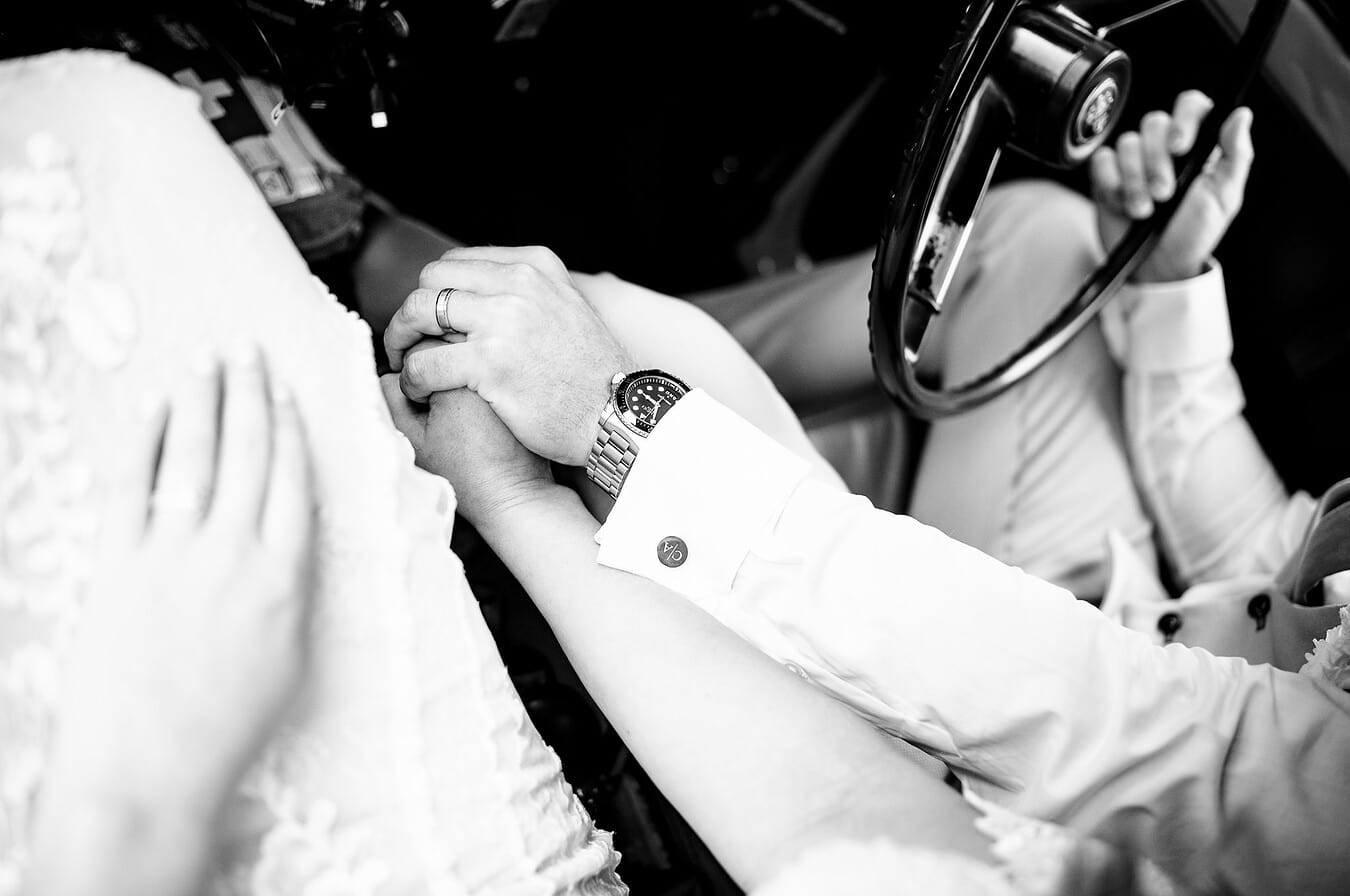 Holding hands in their classic car