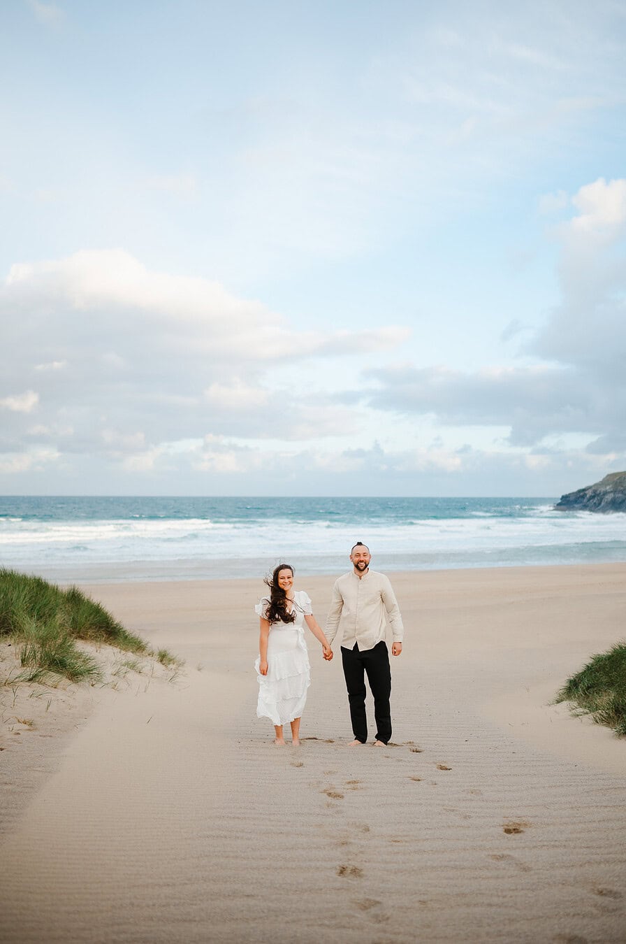 Holding hands on a beach in Cornwall