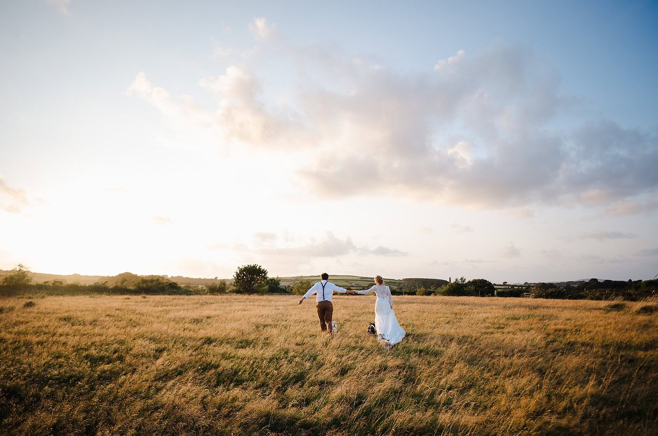 Running through the golden fields at sunset during the couples portraits