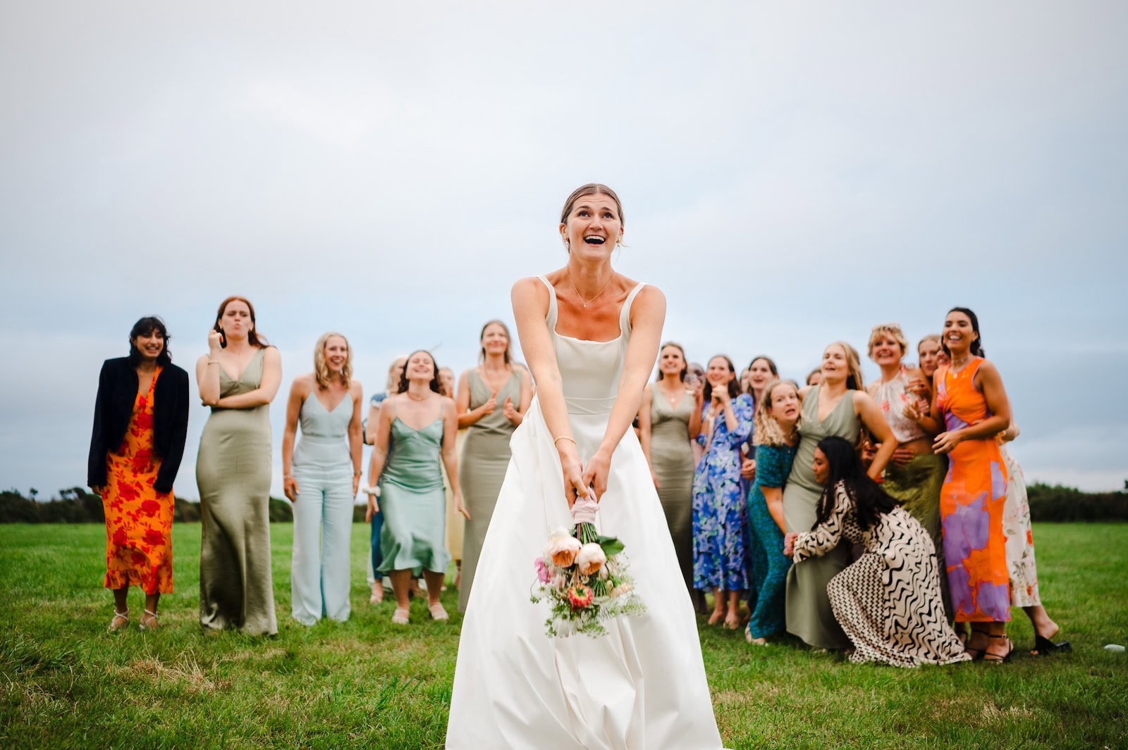The Bride tosses the bouquet towards the wedding guest - Wedding Photography