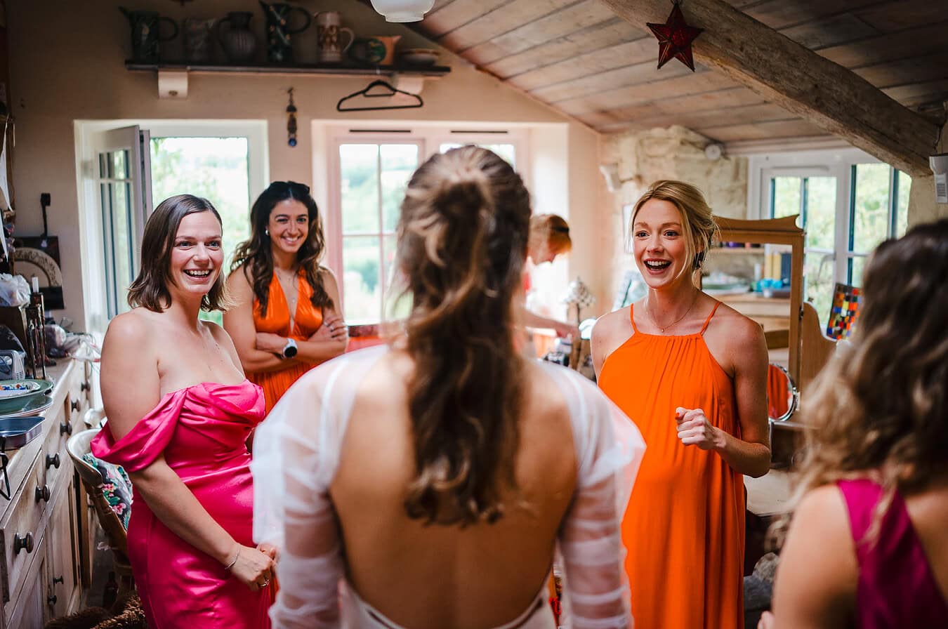 Bridesmaids having the big reveal from the bride