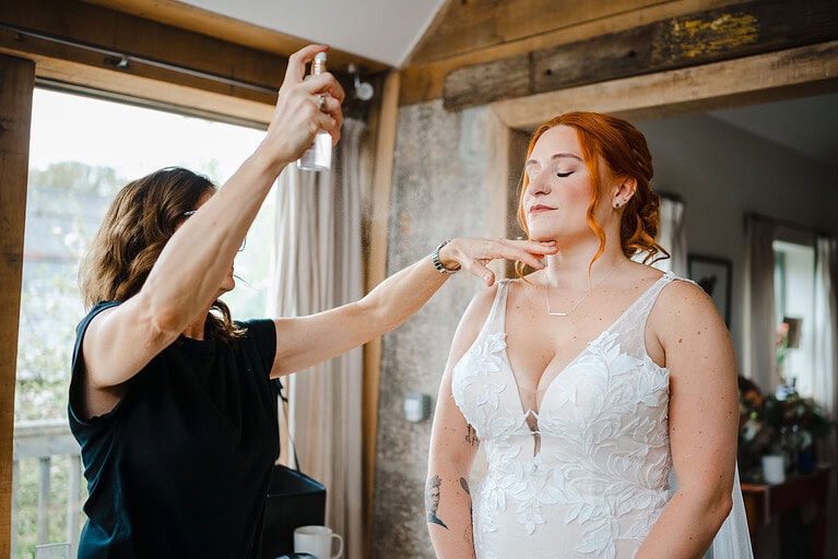 The Brides makeup having finishing touches to her wedding makeup
