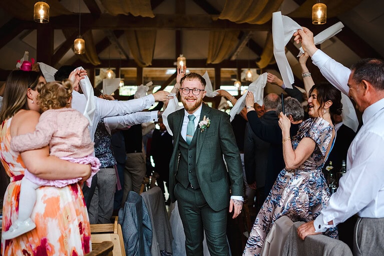 Groom and bride makes their entrance to their wedding reception at Nancarrow farm - By Nancarrow Wedding Photographer - Jake Timms Photography