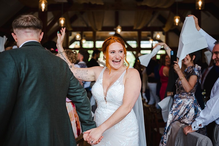 Bride smiles as the couple make their entrance into their Nancarrow Wedding Reception