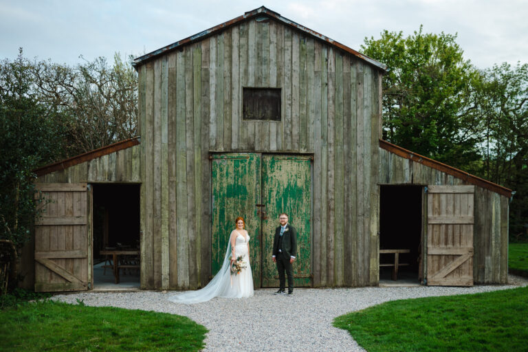 Couple portraits outside the rustic wedding barn at Narncarrow Farm - By Nancarrow Wedding Photographer, Jake Timms Photography