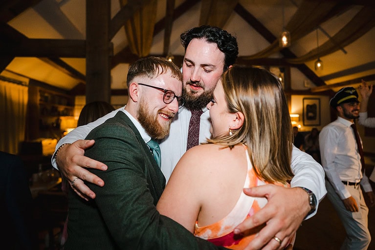 Hugs all round from the wedding guests