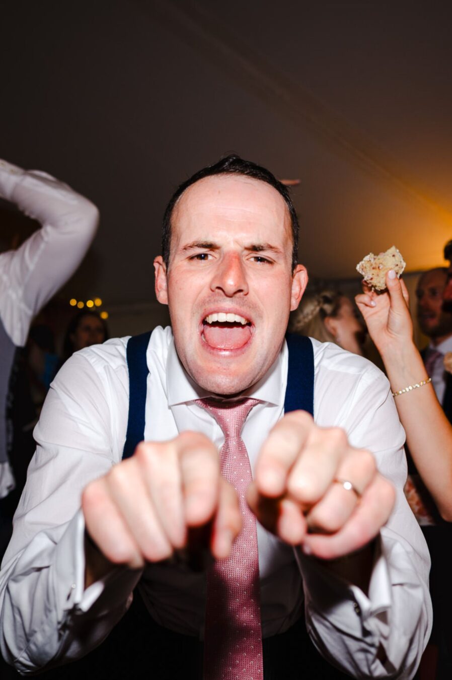 On the dance floor the groom points towards the camera by Cheshire Wedding Photographer - Jake Timms Photography