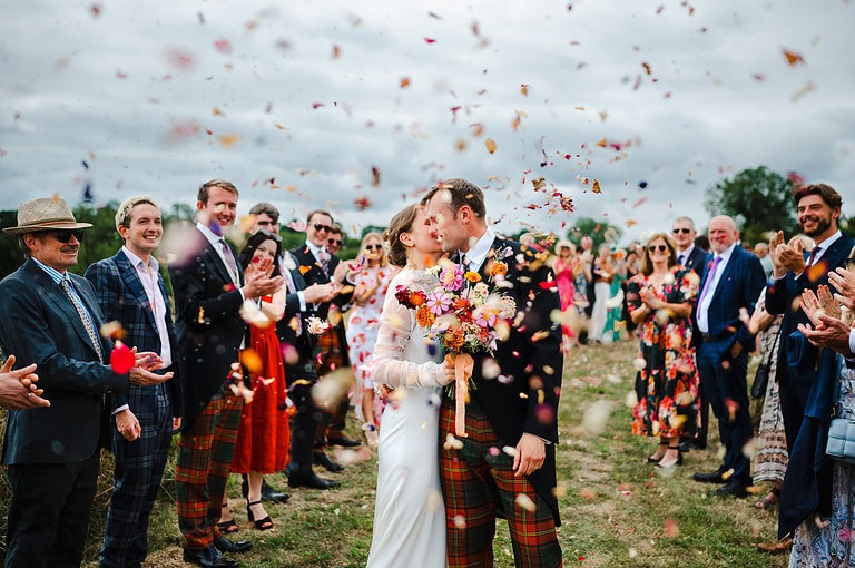 The wedding confetti rains down over the happy couple - Somerset Wedding
