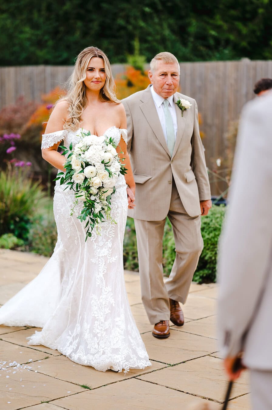 Bride walks down the wedding aisle towards her groom - Cheshire Wedding Photographer