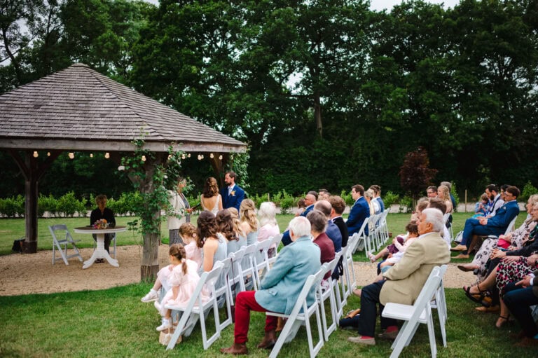 The wedding guests watch as the bride and groom get married at Froginwell