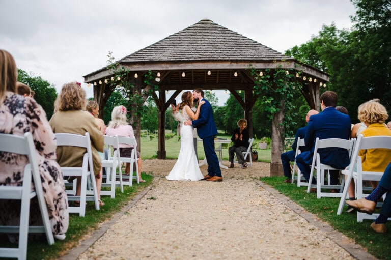 That just married feeling as the happy couple share the moment with a kiss at Froginwell