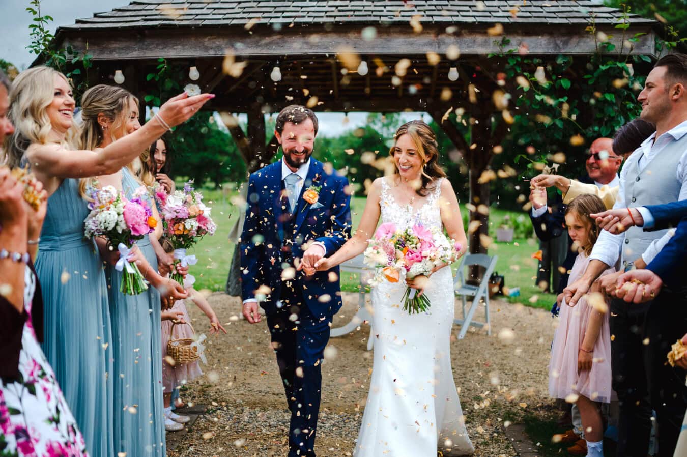 Wedding confetti gets pured over the happy couple after saying I do back down the Froginwell wedding aisle by Cornwall Wedding Photographer Jake Timms Photography