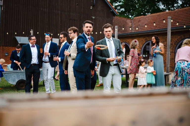 Wedding guests throw the hoop at the garden games