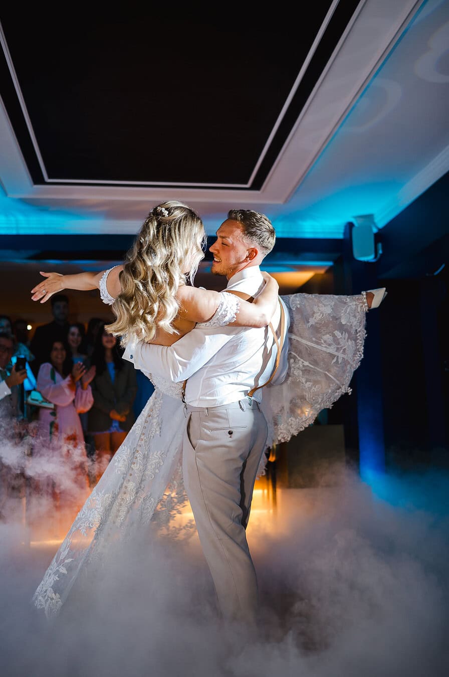 The groom picks up the bride during their first dance at The Pear Tree Purton by Jake Timms Photography