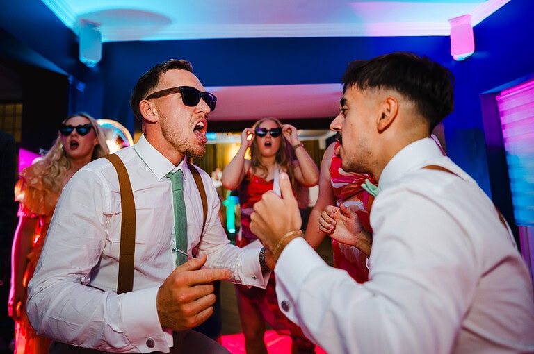 Groom and best man strut their stuff on the dance floor at The Pear Tree Purton by Jake Timms Photography