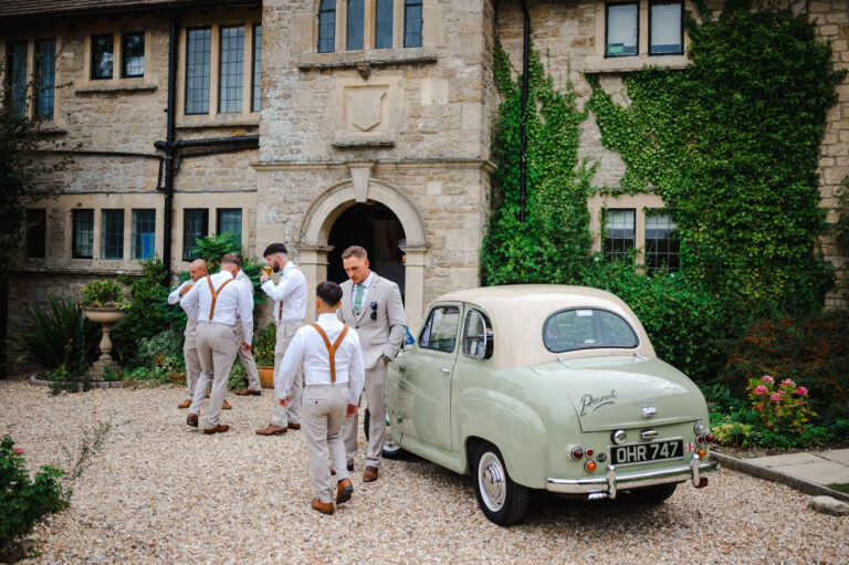 Outside the pear tree the groomsmen gather alongside their classic car