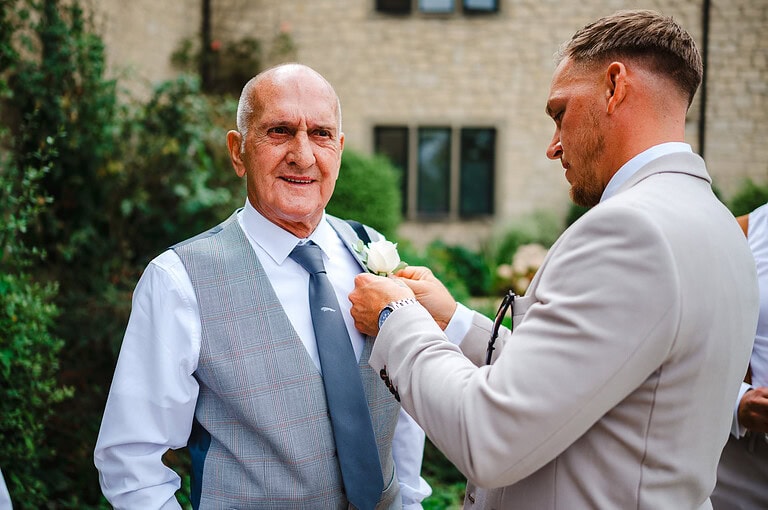 Fastening the wedding buttonhole