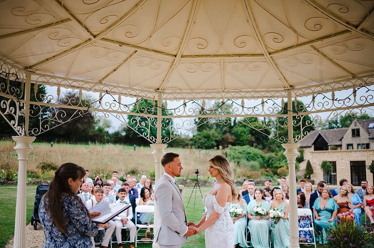 Underneath the canopy during the wedding ceremony at The Pear Tree - By Jake Timms Photography