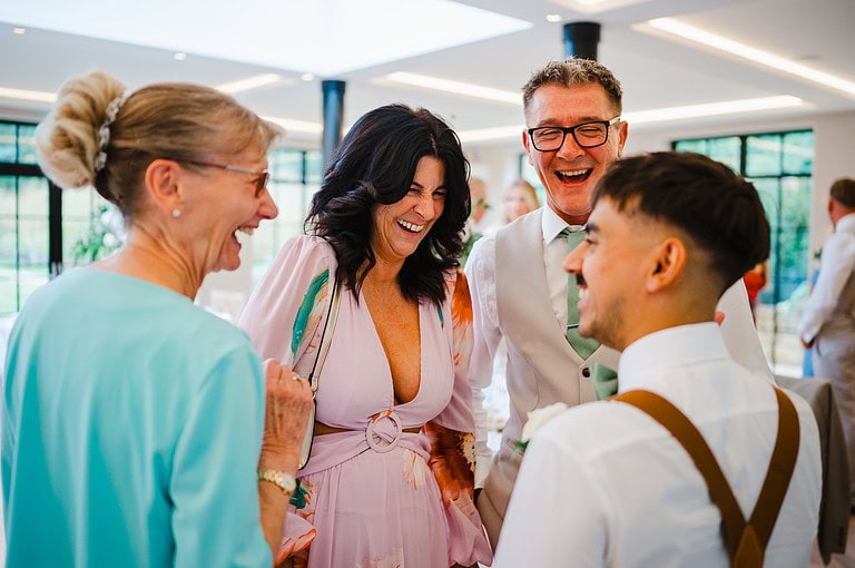 Laughter as a group gathers round the best man