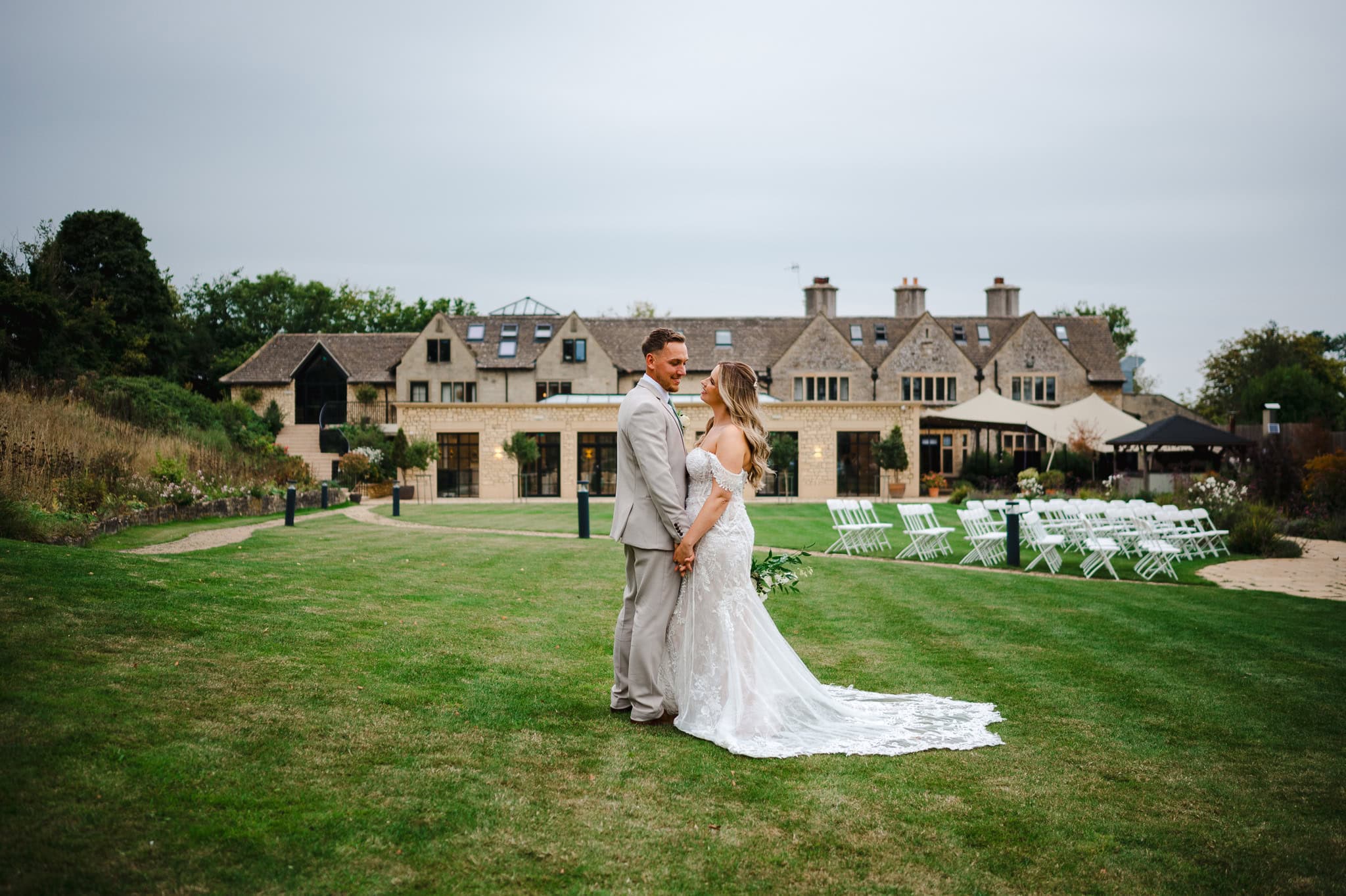 Standing proud posing for their couple photos in front of their wedding venue, The Pear Tree in Purton by Jake Timms Photography