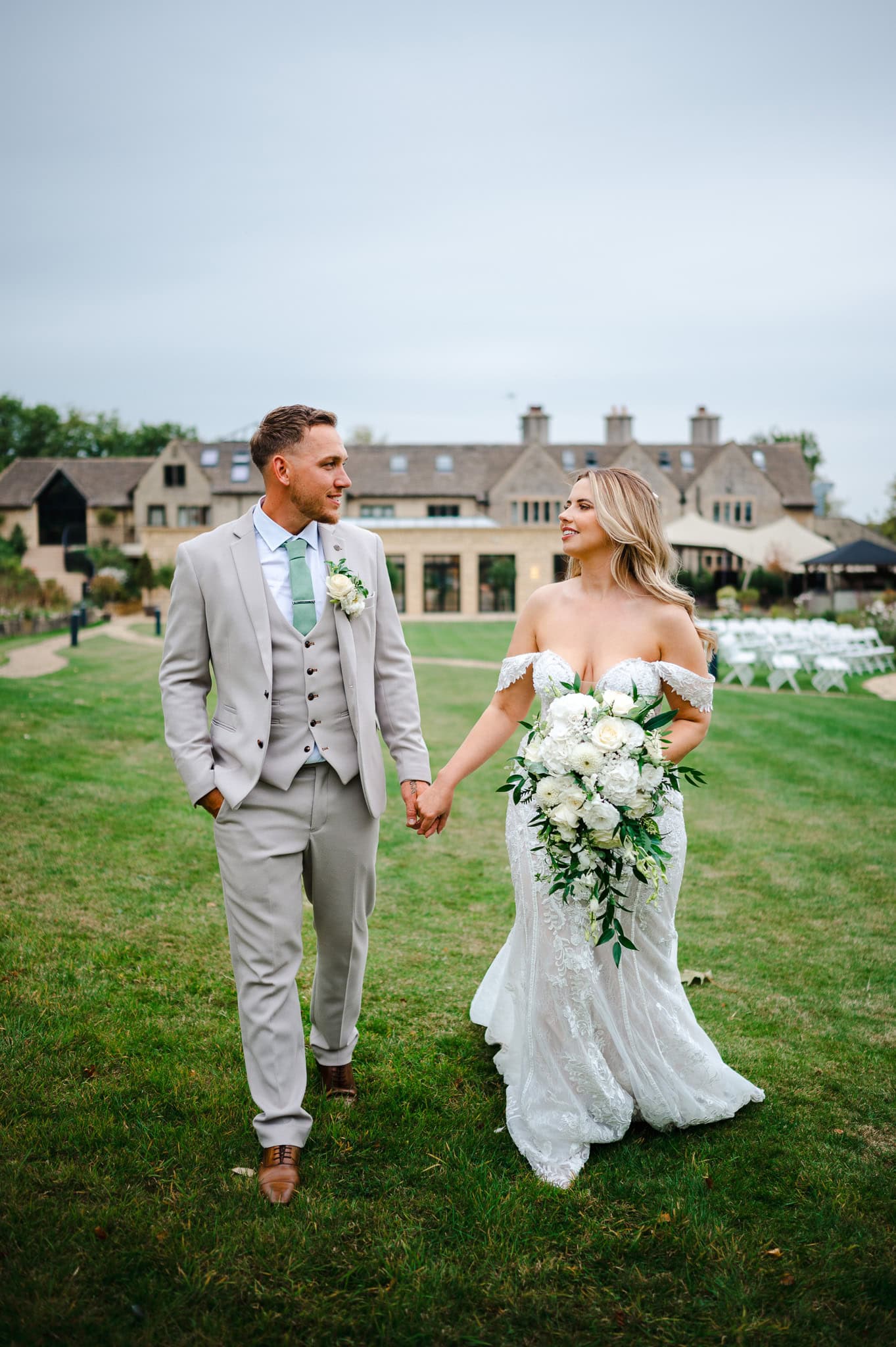 Walking hand in hand outside the stunning Wiltshire Wedding Venue - The Pear Tree By Jake Timms Photography